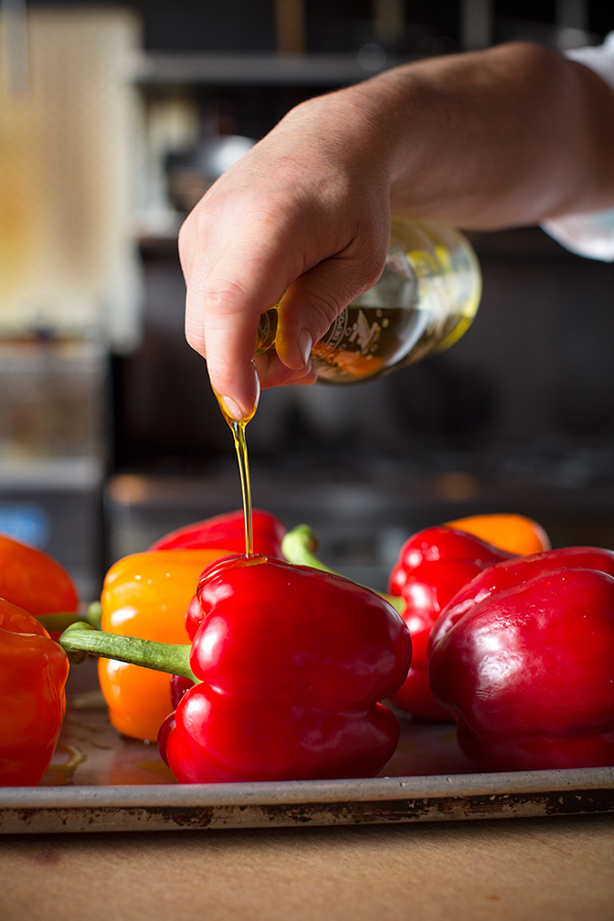 Step One - drizzling the olive oil on your arrangement of peppers.